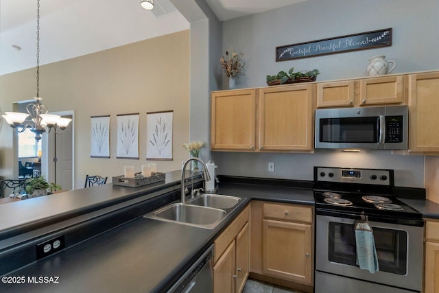 kitchen featuring a chandelier, light brown cabinets, stainless steel appliances, a sink, and dark countertops