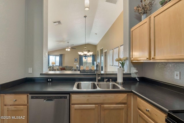 kitchen featuring dark countertops, vaulted ceiling, dishwasher, and a sink