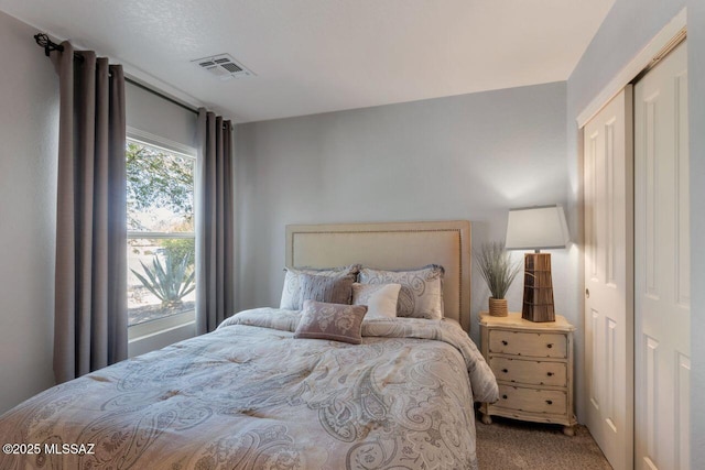 carpeted bedroom with visible vents