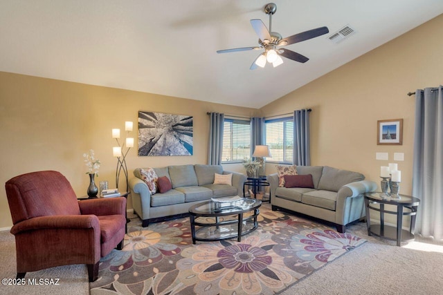 living room featuring lofted ceiling, ceiling fan, carpet floors, visible vents, and baseboards