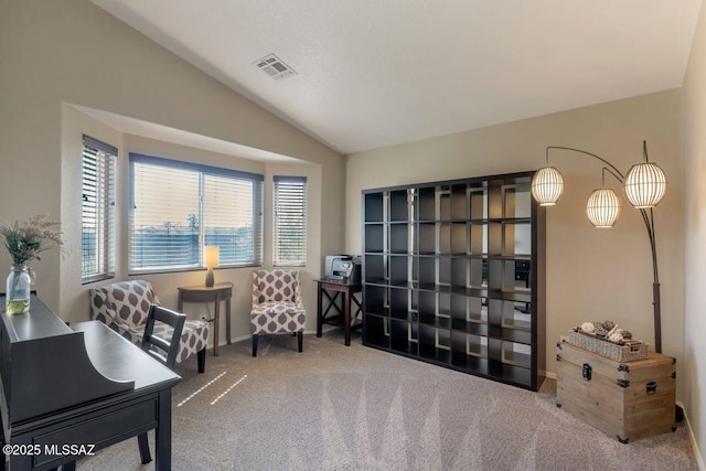 carpeted office with lofted ceiling, visible vents, and baseboards