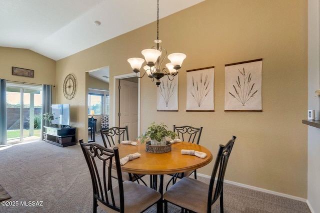 dining space with carpet floors, an inviting chandelier, baseboards, and lofted ceiling