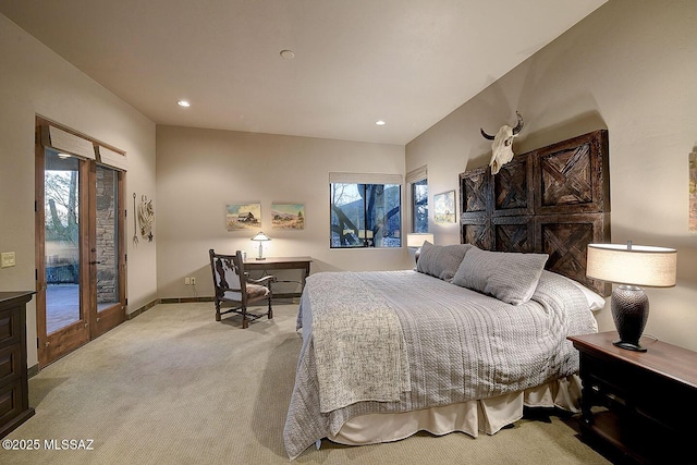 bedroom with light colored carpet, access to exterior, and multiple windows