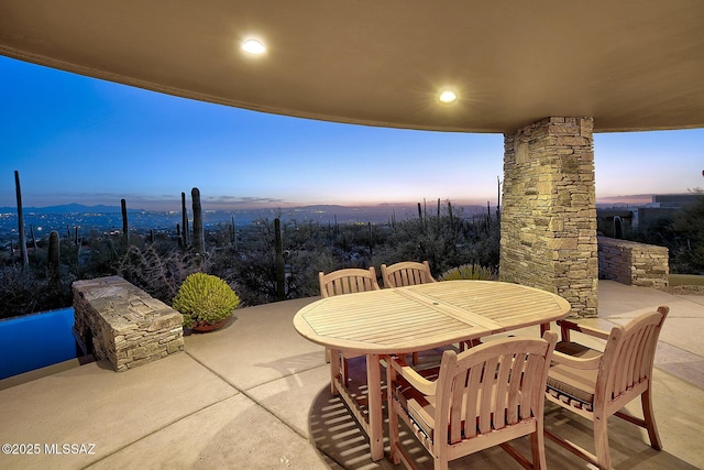 patio terrace at dusk with a mountain view