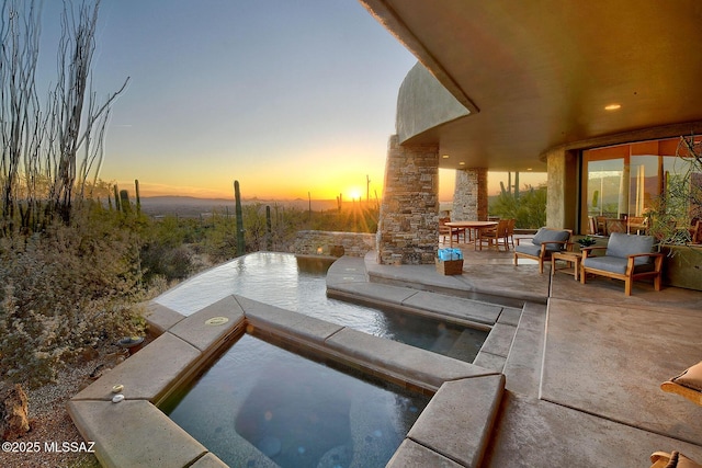 view of patio terrace at dusk