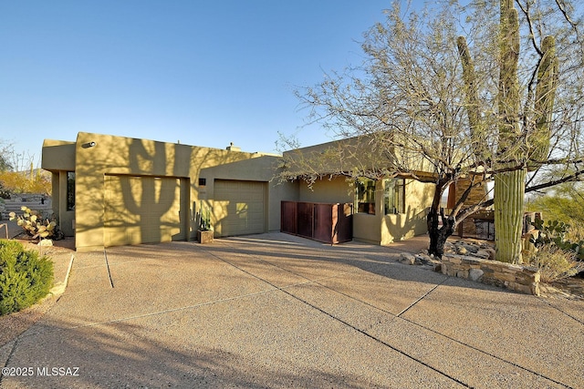 pueblo-style house with a garage