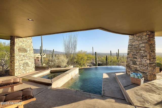 view of pool with an in ground hot tub