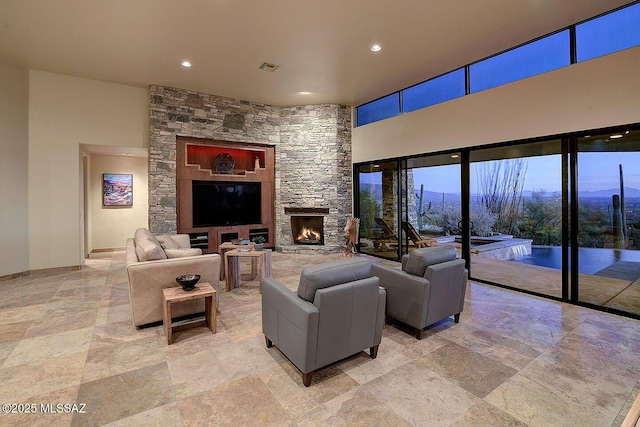 living room featuring a stone fireplace