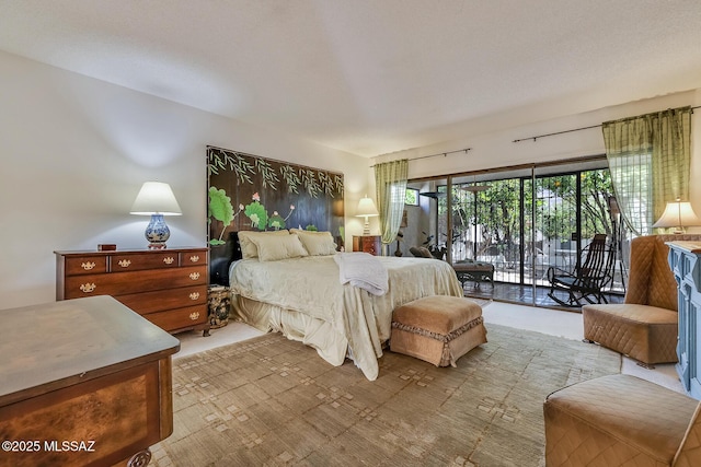 bedroom with access to outside and carpet flooring