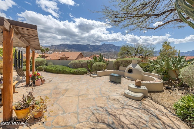 view of patio / terrace featuring a mountain view and fence