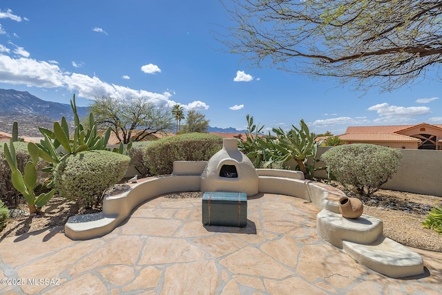 view of patio featuring a mountain view and a fenced backyard