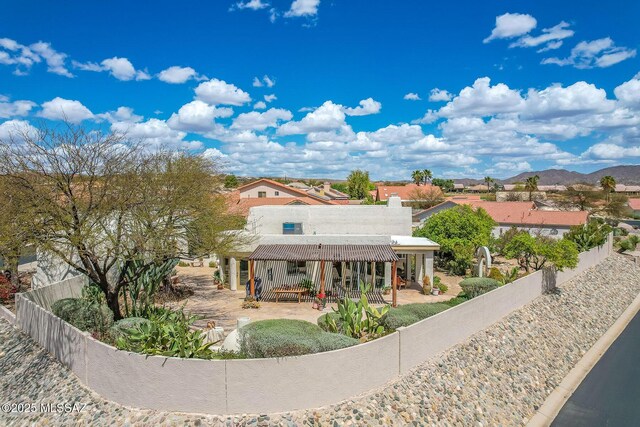 rear view of house with a patio and a fenced backyard