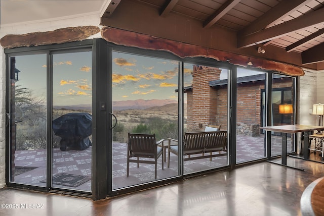 doorway featuring lofted ceiling with beams and wooden ceiling