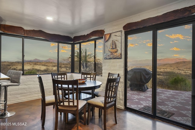 dining space featuring a mountain view and concrete floors