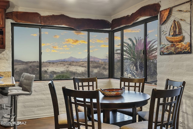 dining room featuring hardwood / wood-style flooring and a mountain view