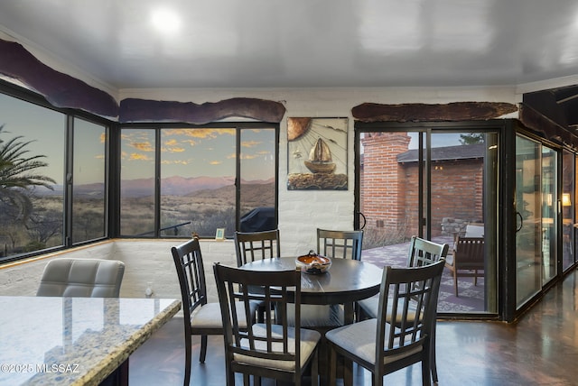 dining room with a mountain view and crown molding