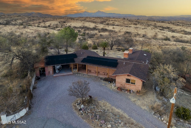 aerial view at dusk featuring a mountain view