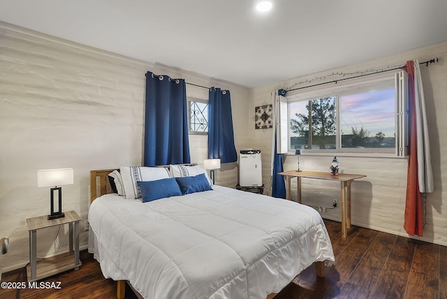 bedroom with dark hardwood / wood-style flooring