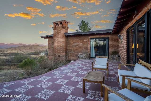 patio terrace at dusk with a mountain view