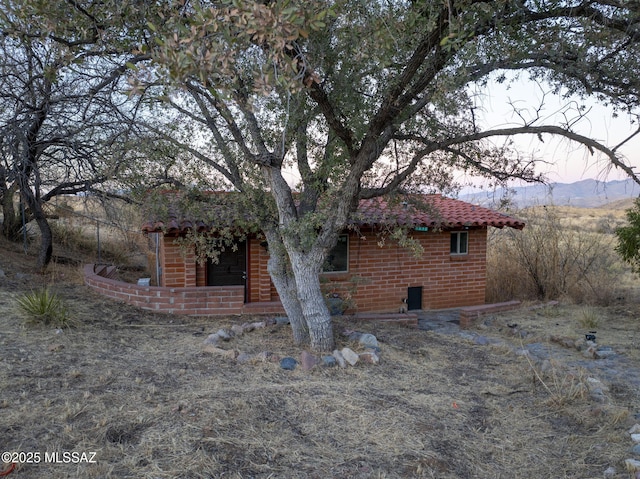 back house at dusk featuring a mountain view