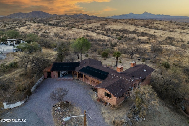 aerial view at dusk featuring a mountain view