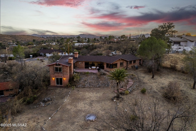 aerial view at dusk featuring a mountain view