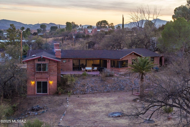 back house at dusk with a mountain view