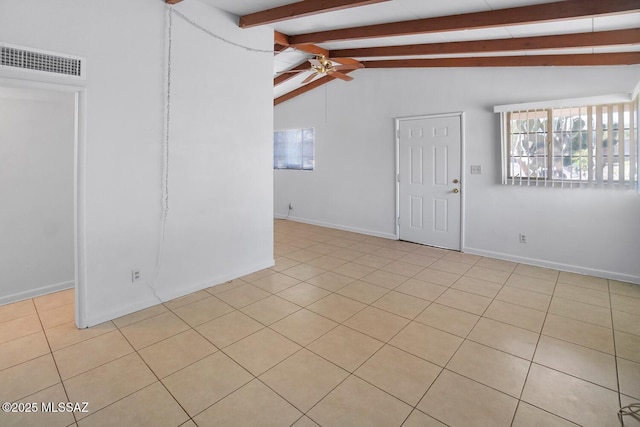 unfurnished room with light tile patterned floors, plenty of natural light, lofted ceiling with beams, and ceiling fan