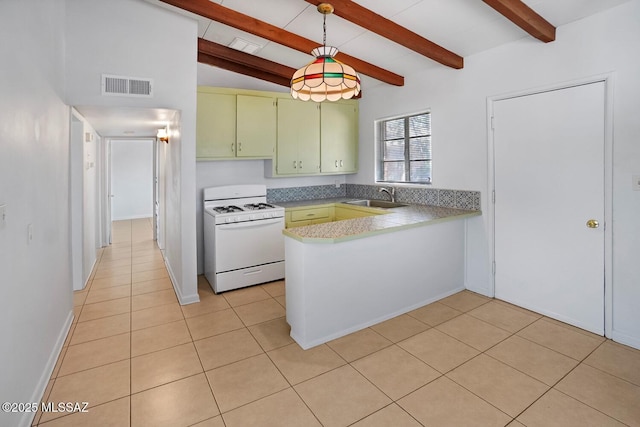 kitchen with light tile patterned floors, sink, hanging light fixtures, white gas range, and kitchen peninsula