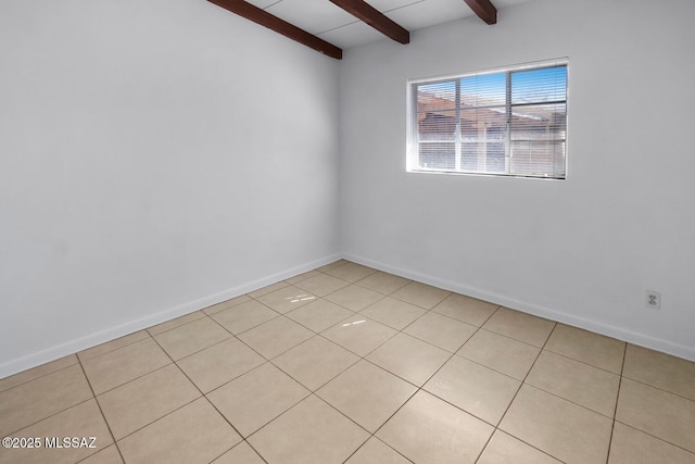 spare room featuring beamed ceiling