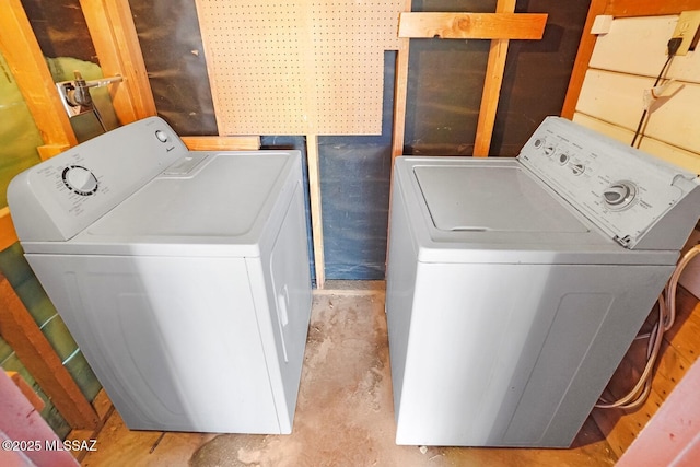 clothes washing area with washer and clothes dryer