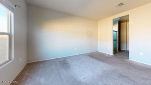 carpeted spare room featuring visible vents