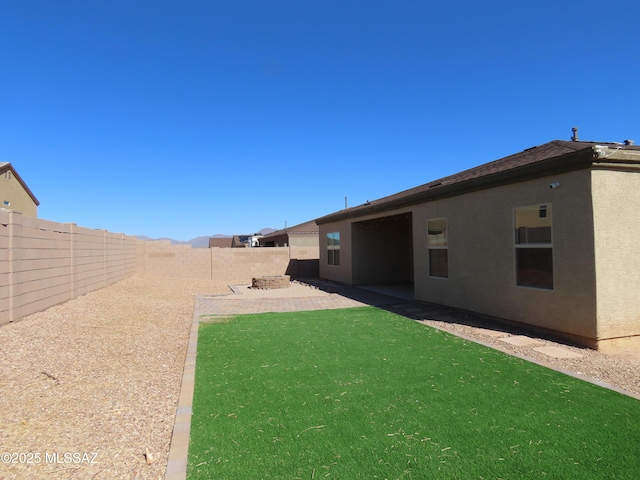 view of yard featuring a patio area and a fenced backyard