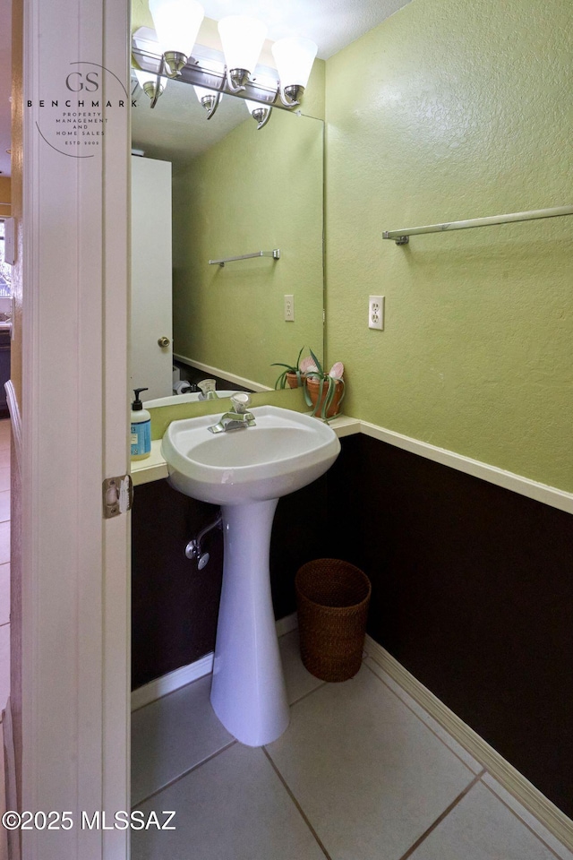 bathroom with tile patterned floors and baseboards