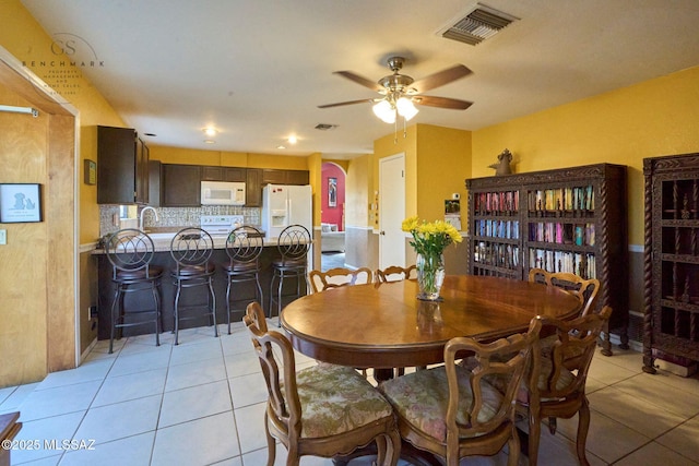 dining area with light tile patterned flooring, visible vents, and ceiling fan