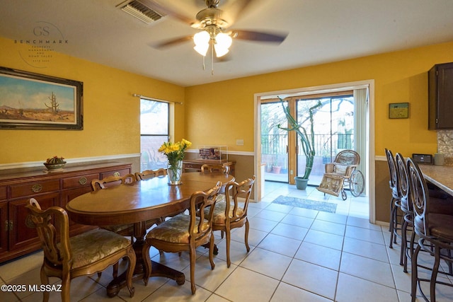 dining room with ceiling fan, visible vents, and light tile patterned flooring