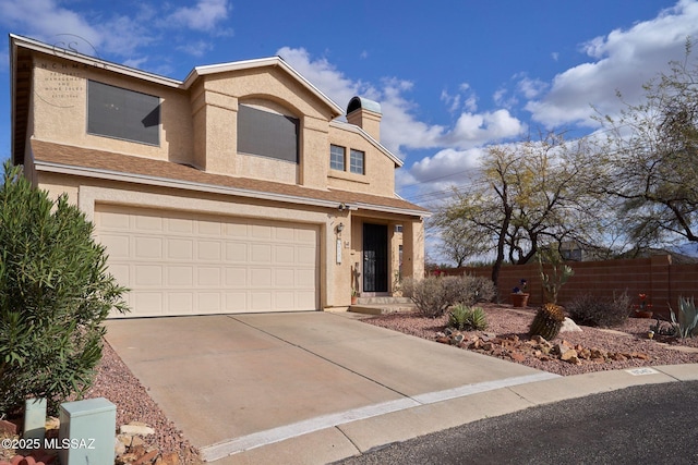 view of front of home with fence, an attached garage, a chimney, stucco siding, and concrete driveway