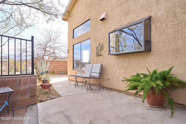 view of patio / terrace featuring fence