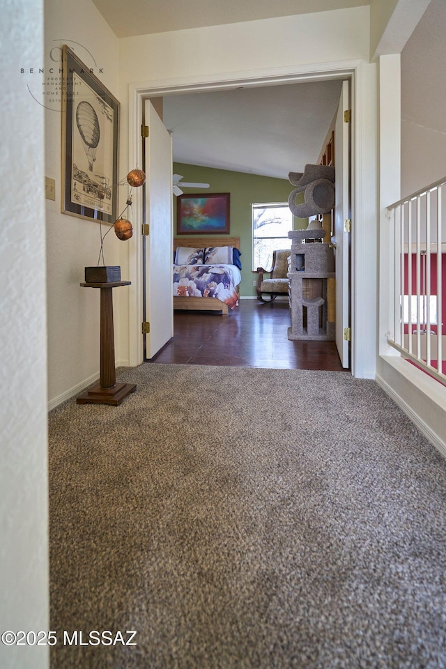 hallway with baseboards and carpet floors