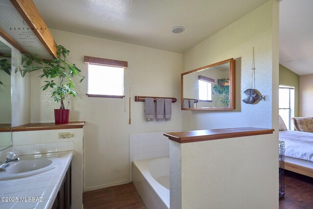 bathroom with vanity, toilet, wood finished floors, and visible vents