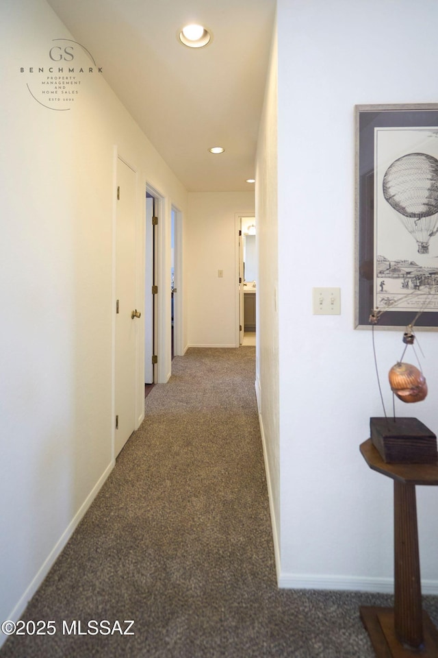 hallway featuring recessed lighting, baseboards, and carpet