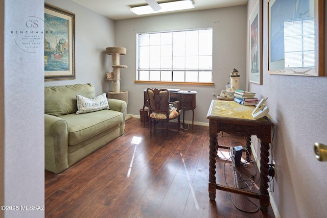 living area featuring hardwood / wood-style flooring and baseboards