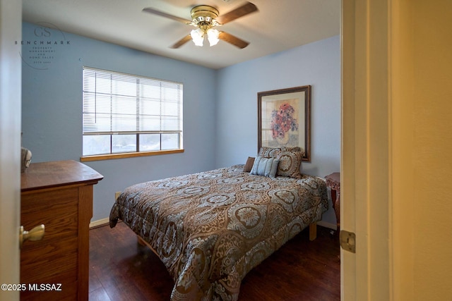 bedroom featuring ceiling fan, baseboards, and wood finished floors