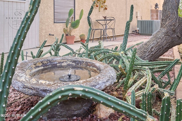 details featuring central air condition unit and stucco siding