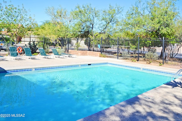 pool featuring a patio area and fence