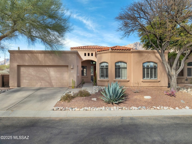 mediterranean / spanish-style house with a garage