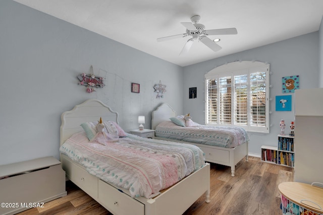 bedroom with ceiling fan and hardwood / wood-style floors