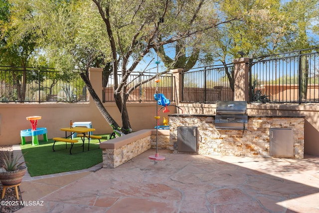 view of patio featuring area for grilling and exterior kitchen