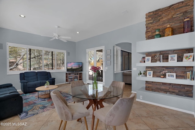 dining space featuring light tile patterned flooring and ceiling fan