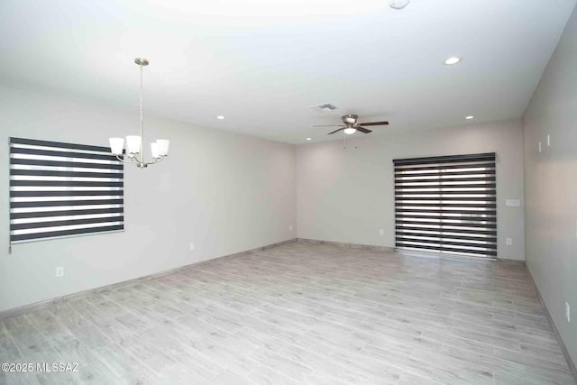 unfurnished living room featuring visible vents, baseboards, recessed lighting, ceiling fan with notable chandelier, and wood finished floors